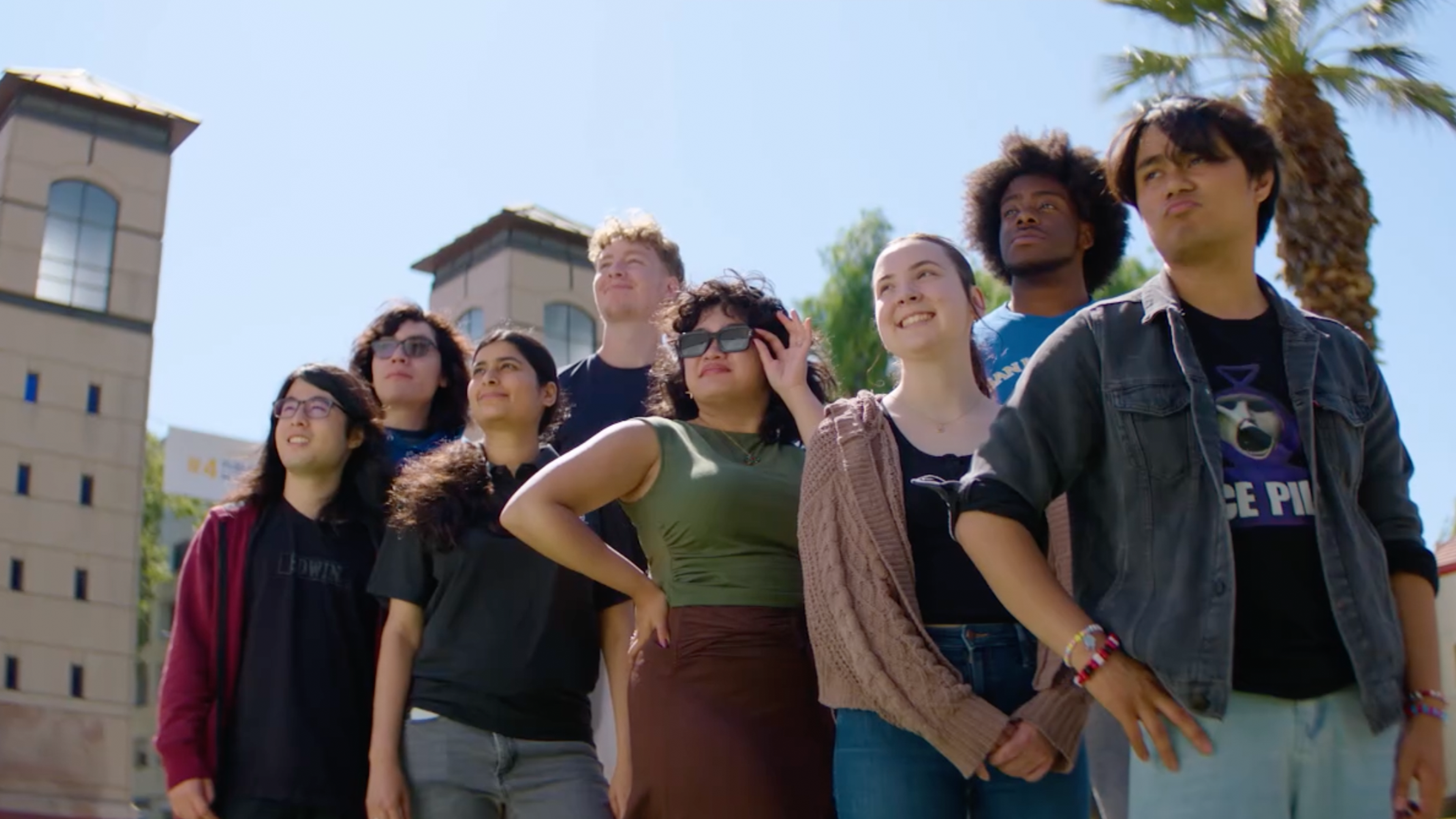 Students standing outside the 4th street gate posing in a group looking out towards the beyond