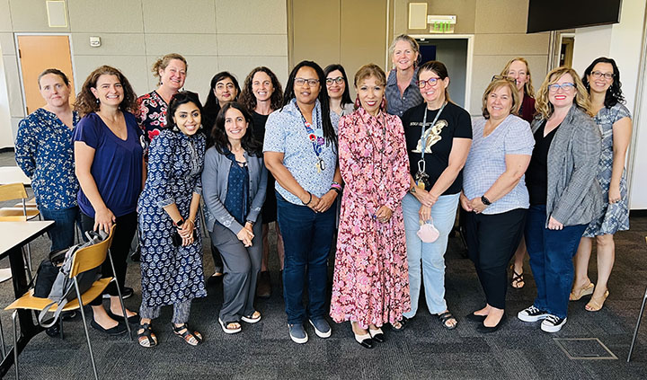 A group of women posing with President Teniente-Matson