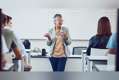 faculty teaching college students from front of classroom.