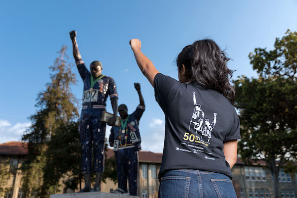 A student with their closed fist in the air.