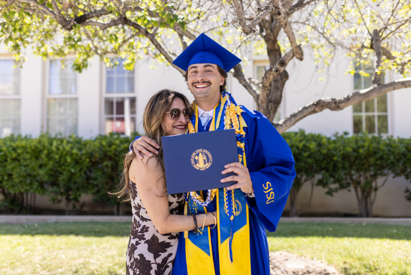 Mother posing with her graduating student