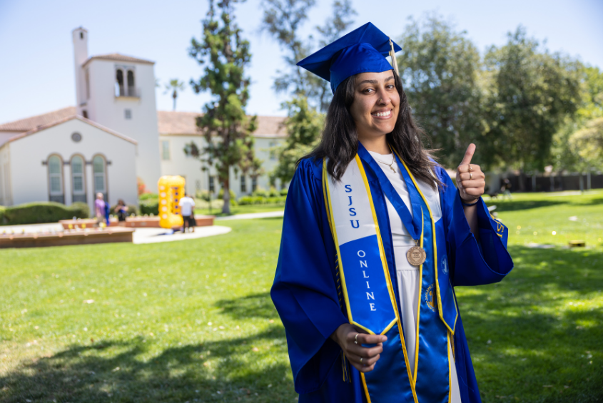 SJSU Online graduate giving a thumbs-up sign