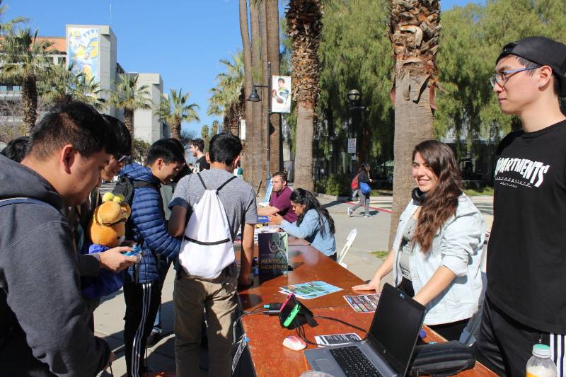 Group of students at a club table in quad