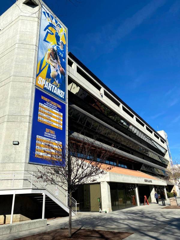 Front of Robert D. Clark Hall entrance with students walking past. 