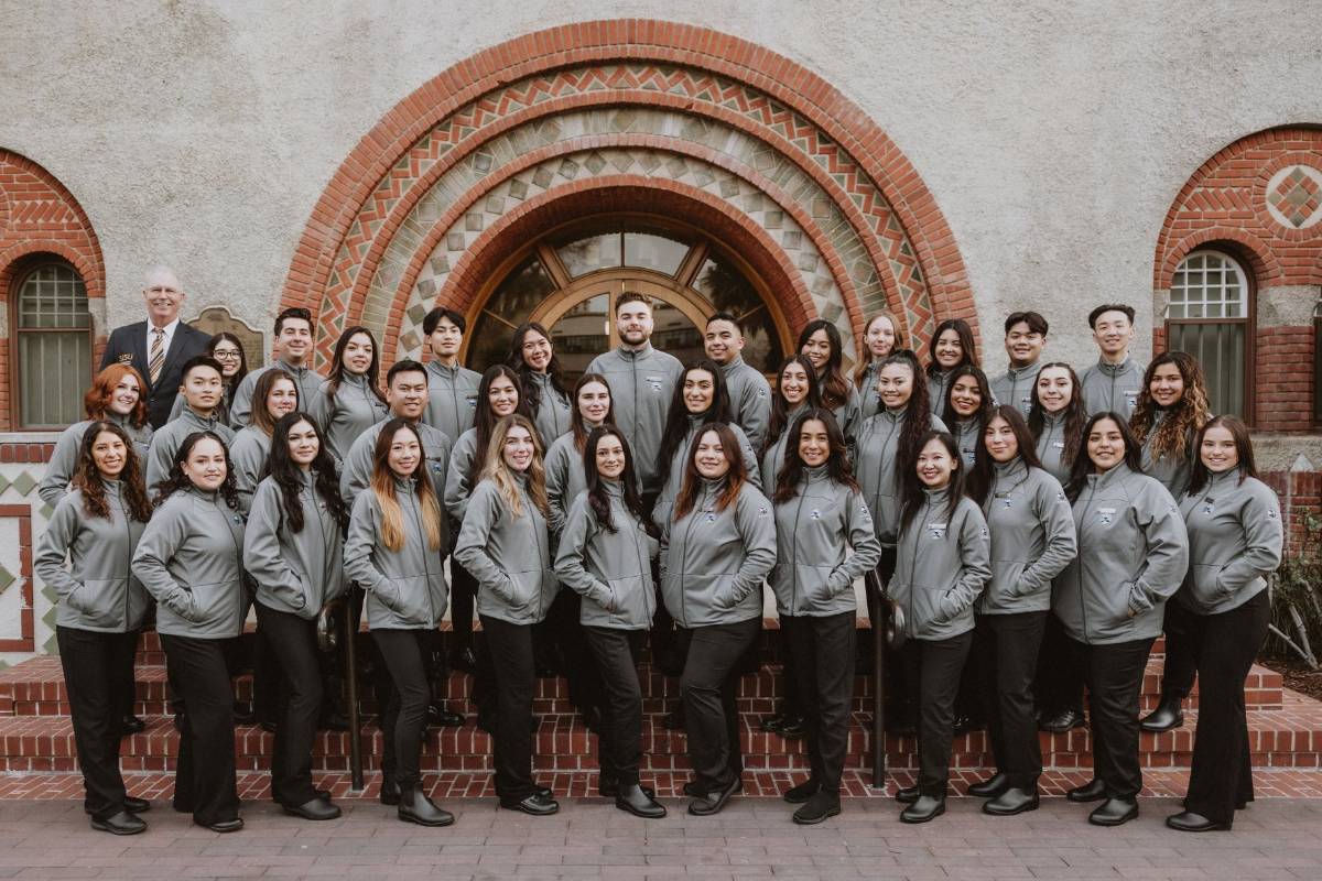 Pebble Beach student team posing in front of archway