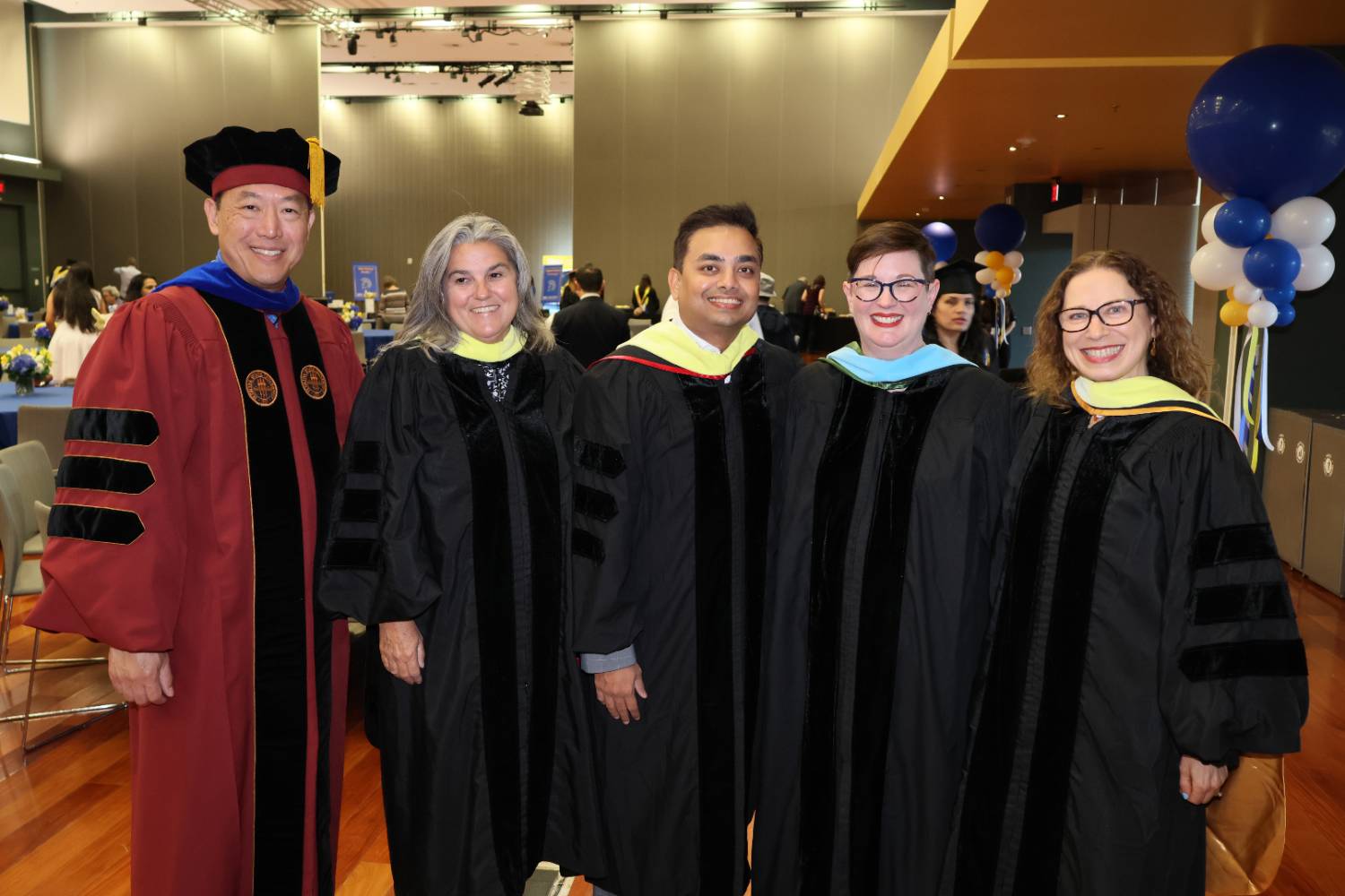 CIDS Deans and Faculty wearing gowns at graduation ceremony