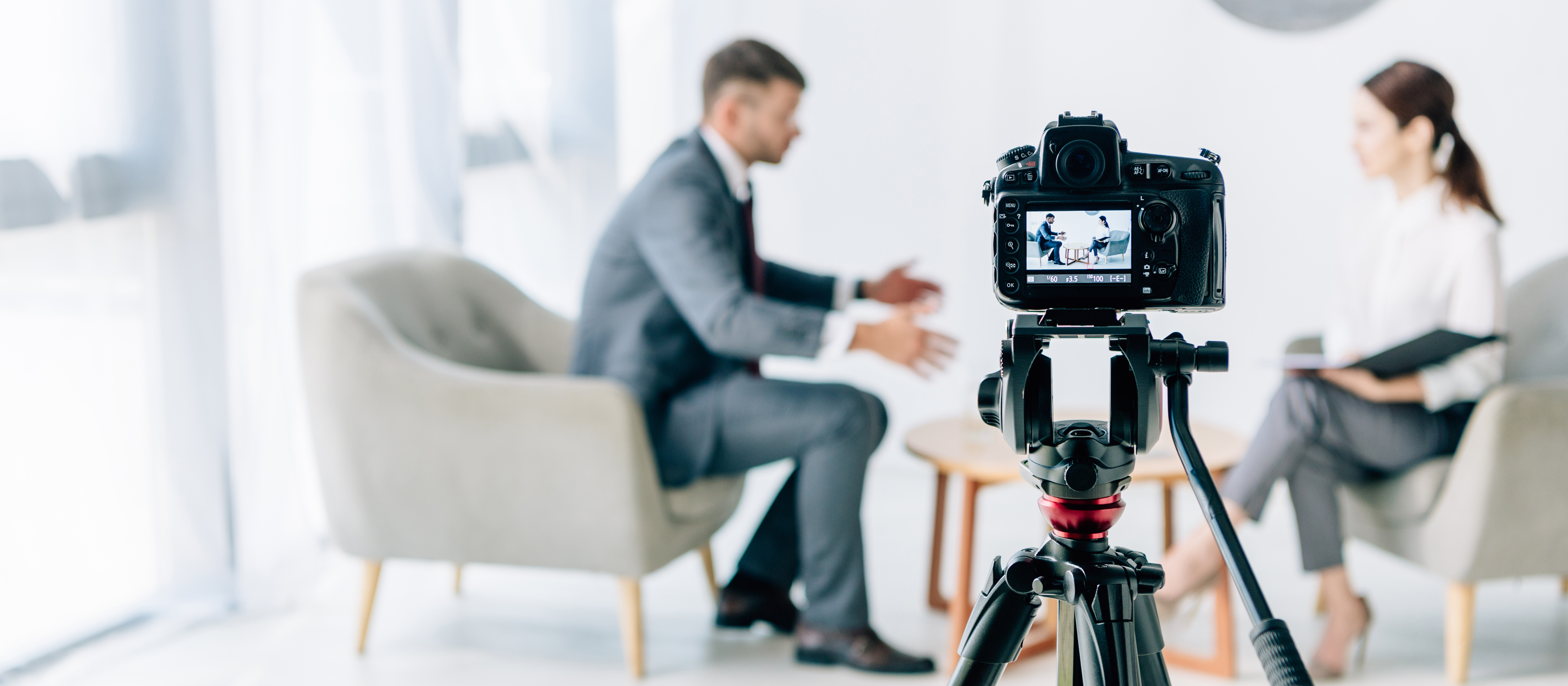 two people talking while being video taped