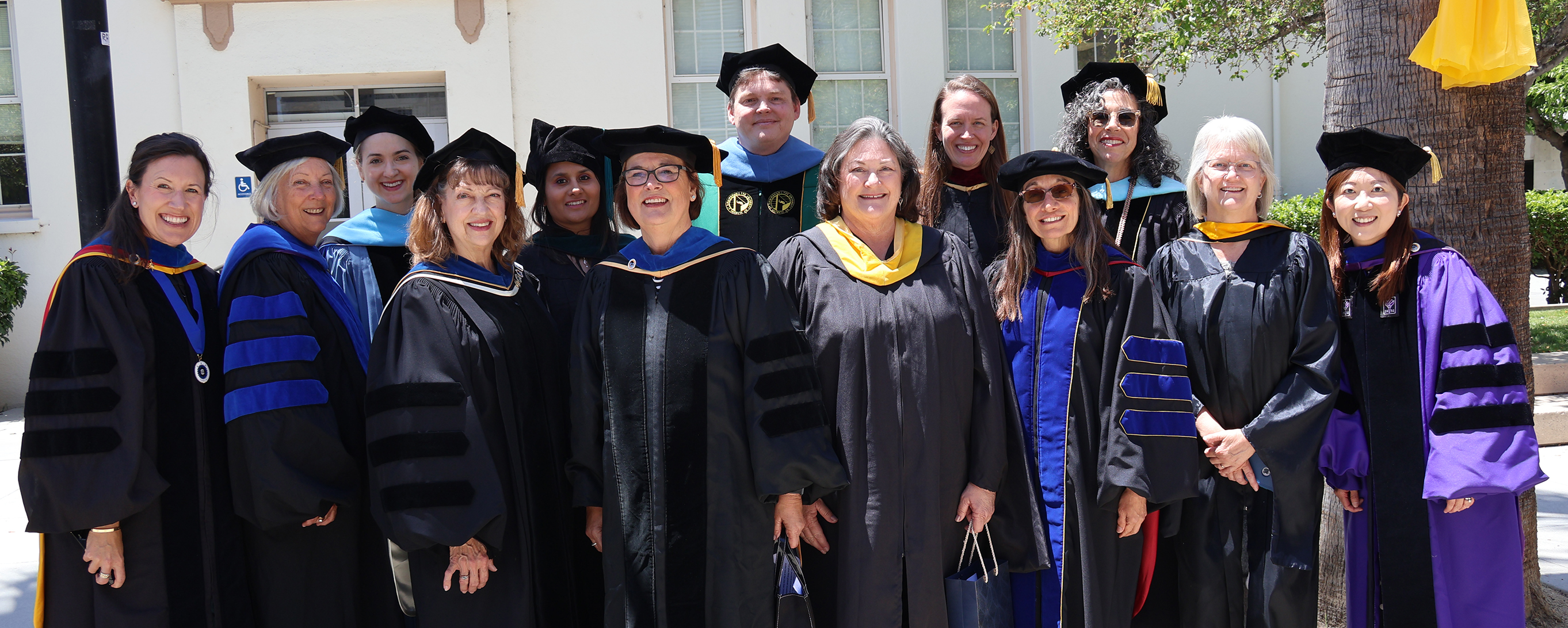 OT faculty in graduatioon regalia group photo in 2024