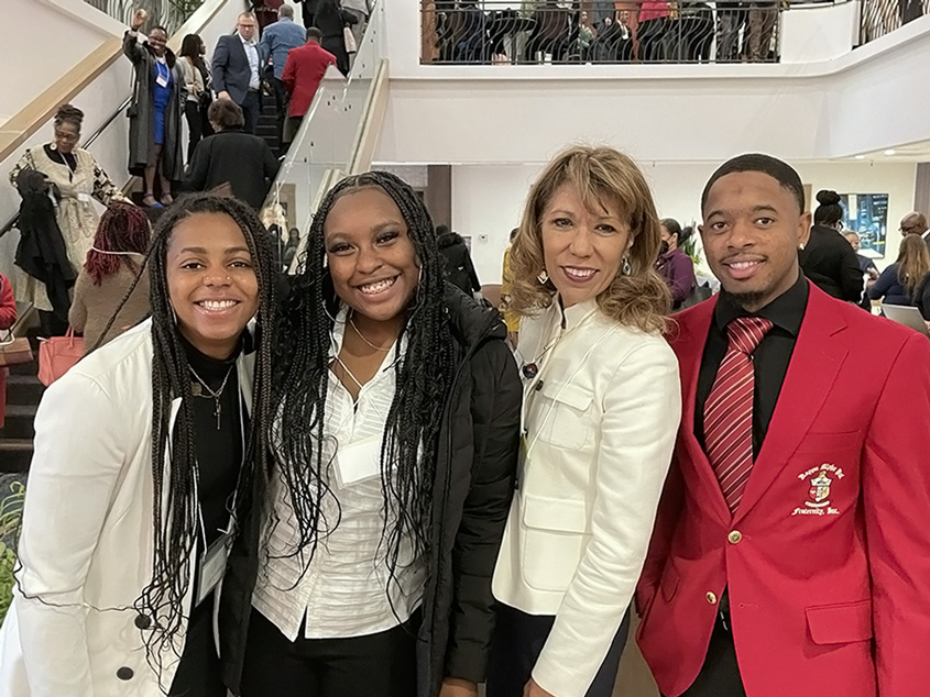 President Teniente-Matson posing with students.