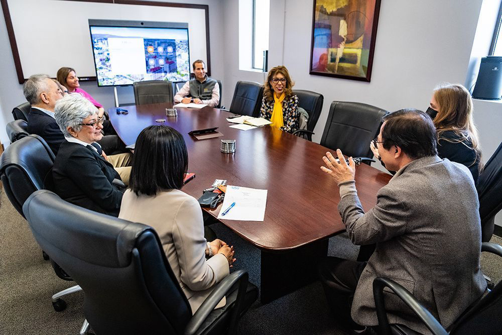 The president attending a meeting with the college of business.