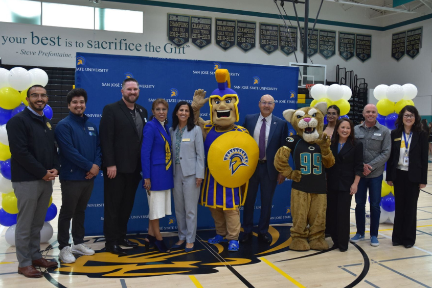 University leadership and Gilroy school district staff pose for a photo.