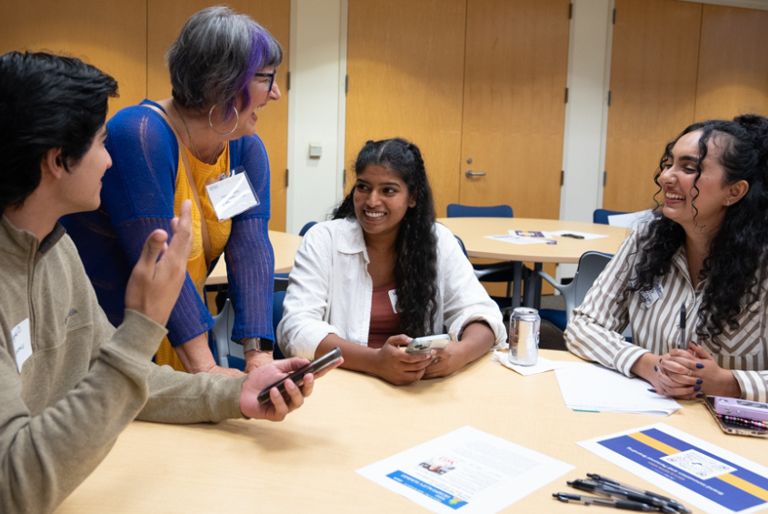 Mentor and students interacting in a classroom.