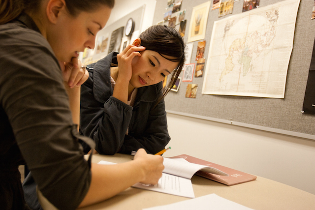 SJSU professor works one on one with a student in the classroom