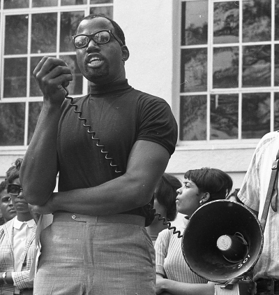 Historical photo of Harry Edwards speaking on a megaphone.